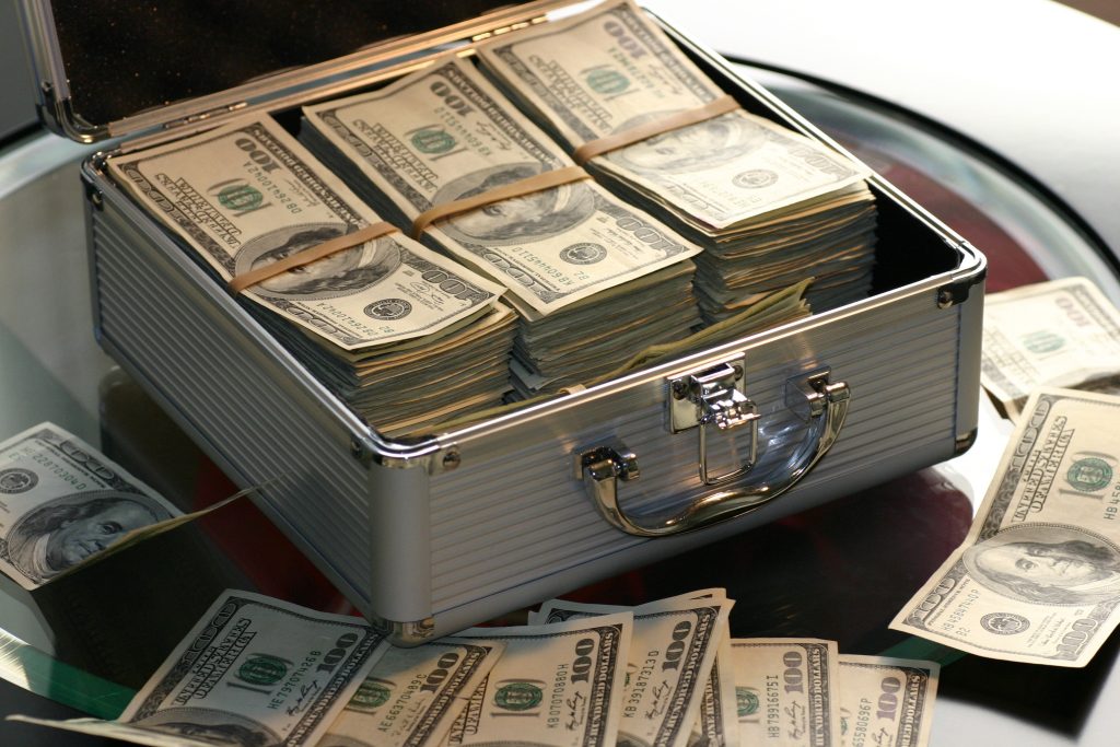 briefcase filled with stacks of dollar bills