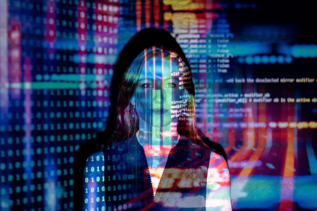 computer code projected over a woman